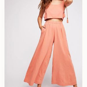 Free People jumpsuit, coral, adjustable straps, wide leg, front cutout. Size M